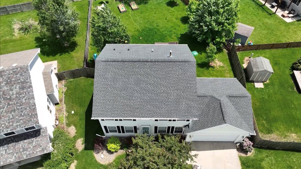 Aerial view of a completed asphalt shingle roof replacement on a metro Atlanta home